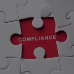 A missing puzzle piece with Compliance written with a red background