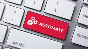 Closeup of a red automate key with gears on a keyboard