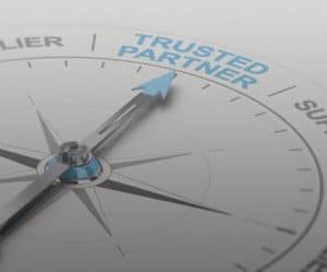 close up of a compass pointer pointing to trusted partner