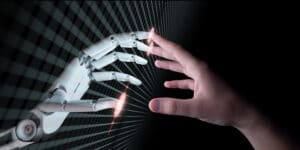 Human hand touching a few fingertips of robot arm